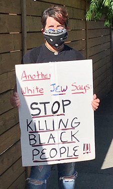 photo showing Penny holding sign that says Stop Killing Black People